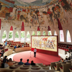 A mural from a local artist adorns the ceiling inside the agora